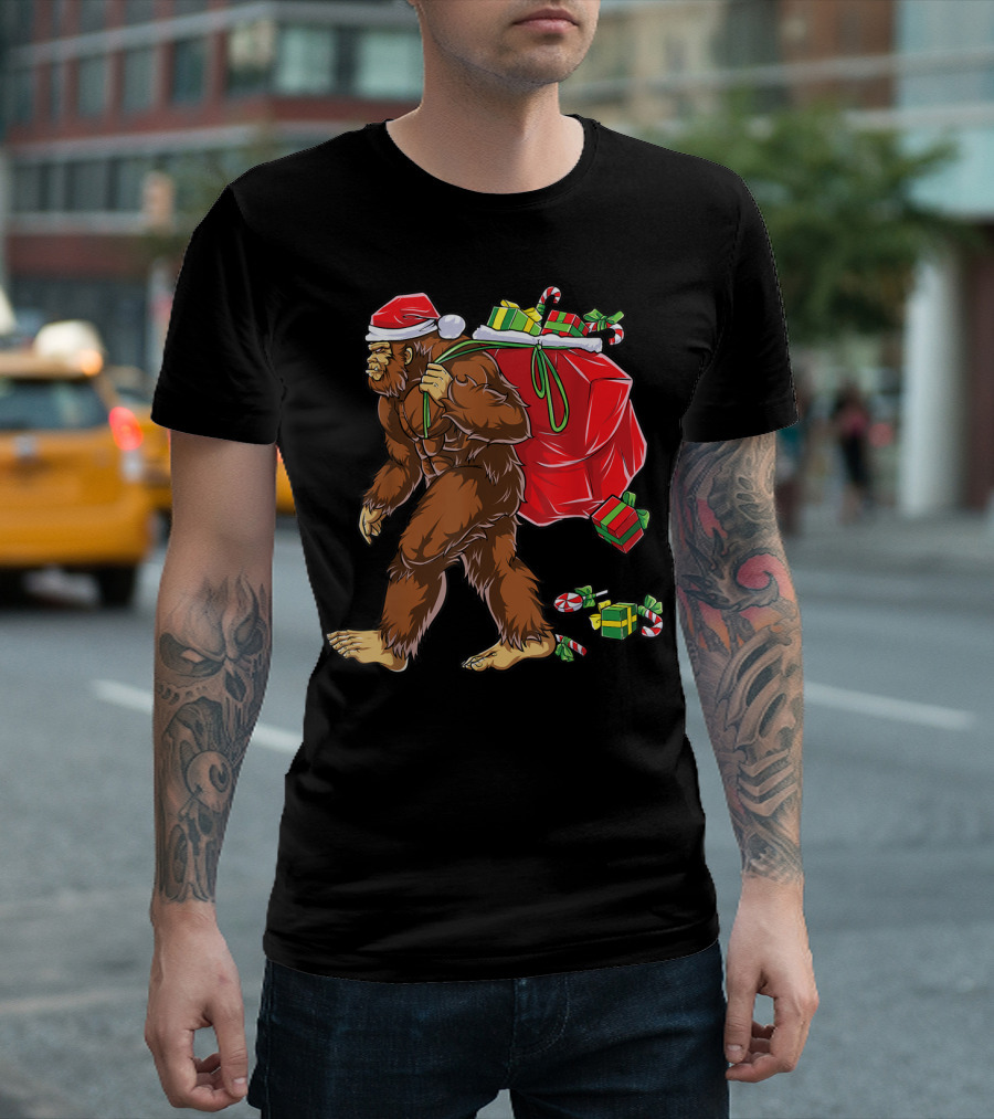Bigfoot Santa with Giant Red Christmas Bag and Green Gifts Wearing Xmas Hat T-Shirt
