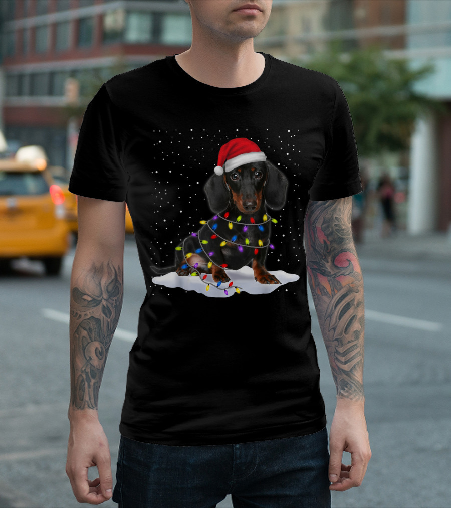 Dachshund Santa Hat Wrapped in Christmas Tree Lights in Snow with Falling Snowflakes T-Shirt