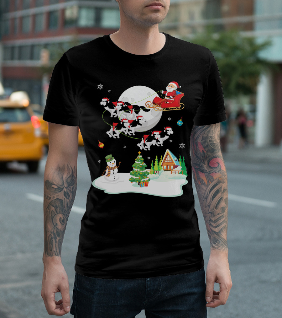 Santa Claus Sleigh Ride With Husky Dogs Over Snowman And Christmas Tree Scene T-Shirt
