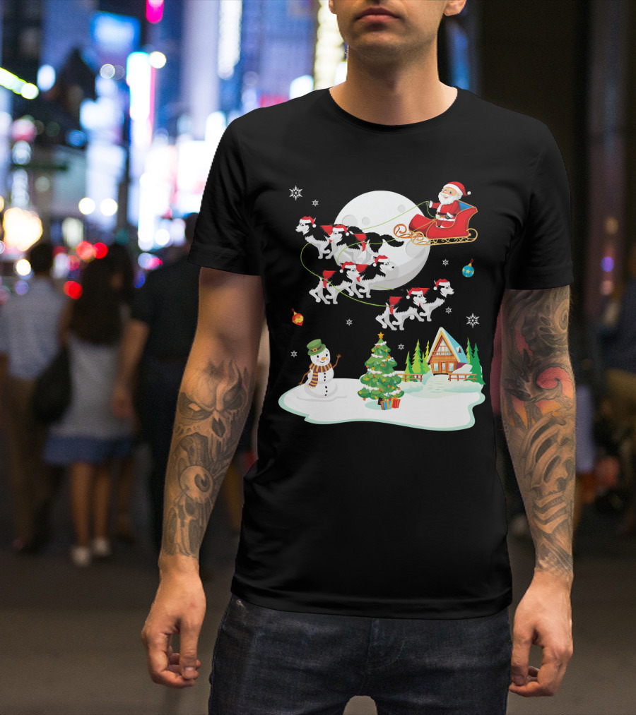 Santa Claus Sleigh Ride With Husky Dogs Over Snowman And Christmas Tree Scene T-Shirt