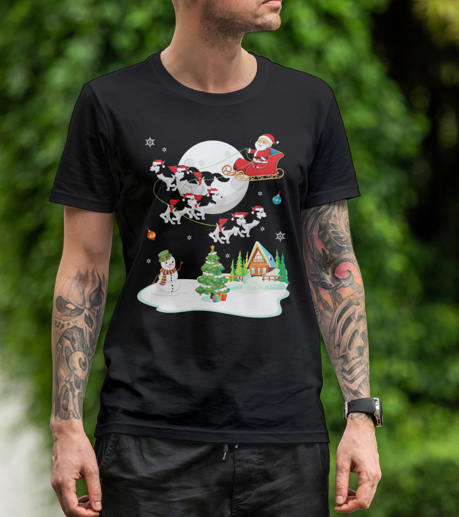 Santa Claus Sleigh Ride With Husky Dogs Over Snowman And Christmas Tree Scene T-Shirt