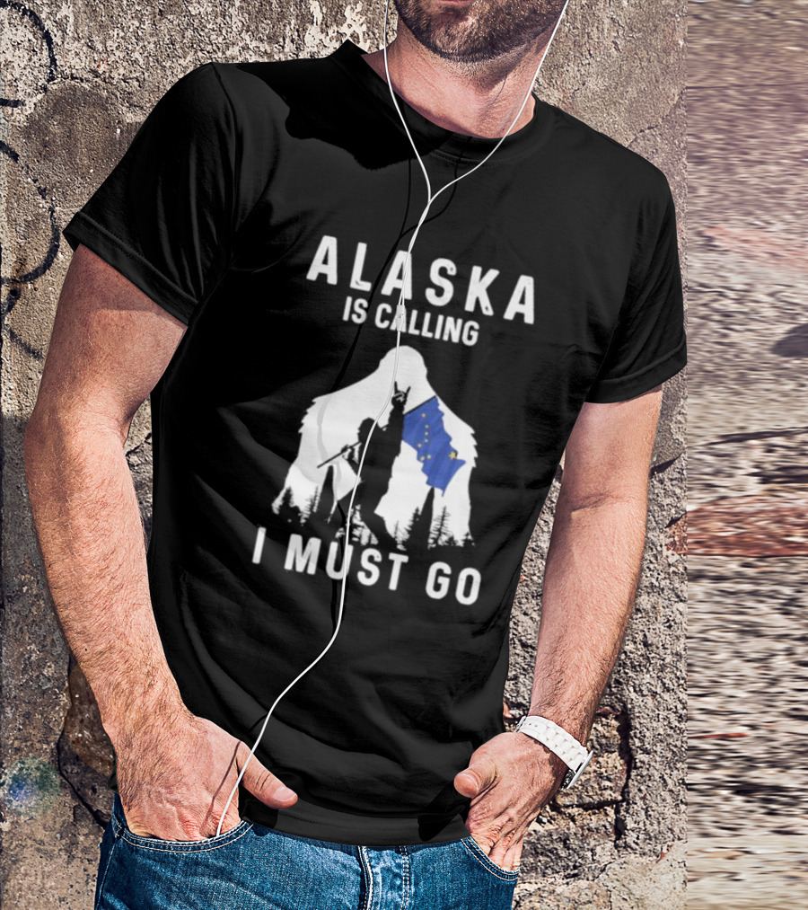 Alaska Is Calling I Must Go Bigfoot Holding Alaska Flag T-Shirt