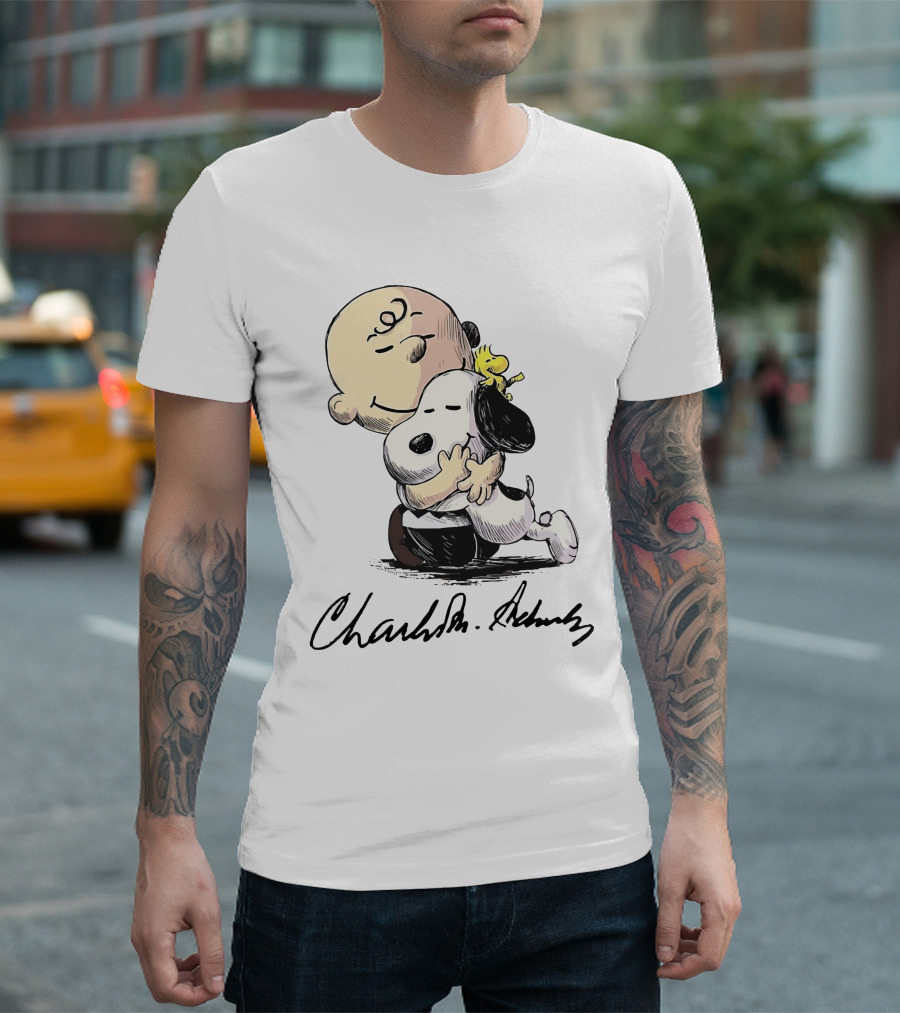 Snoopy and Charlie Brown Hugging by Charles M. Schulz T-Shirt