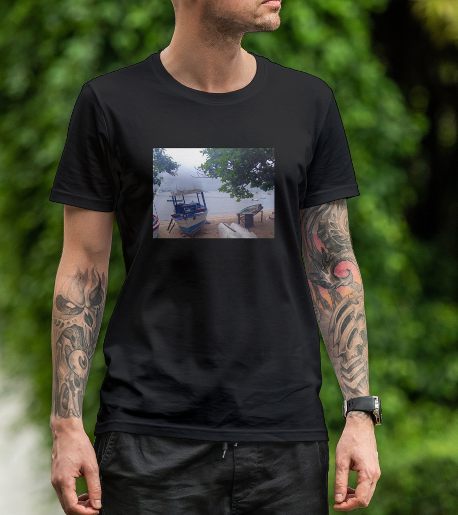 Boats Stopped At The Beach Under Rainy Gray Skies And Lush Green Trees T-Shirt