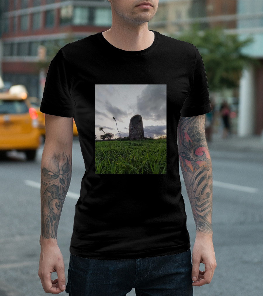 Tomb Of Gigants Majestic Stone Monolith Amidst Lush Green Field Under Dramatic Sky T-Shirt