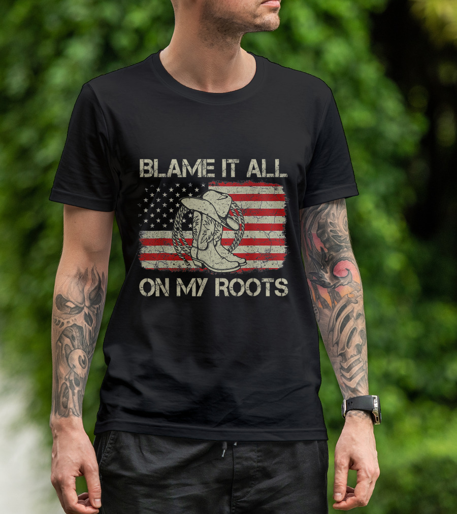 Blame It All On My Roots Cowboy Hat Boots American Flag Background T-Shirt