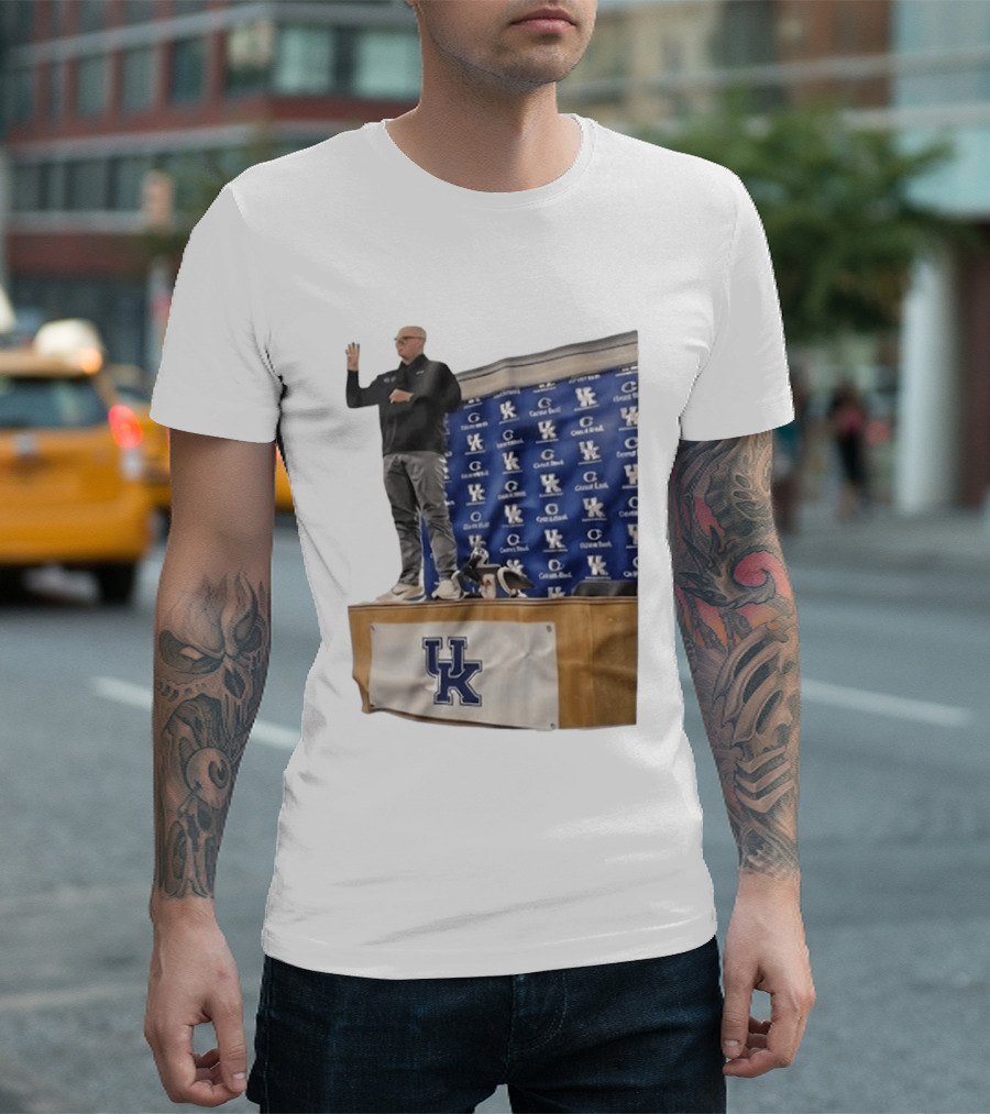 UK Volleyball Coach Craig Skinner Standing On Table With UK Logo And Awards T-Shirt