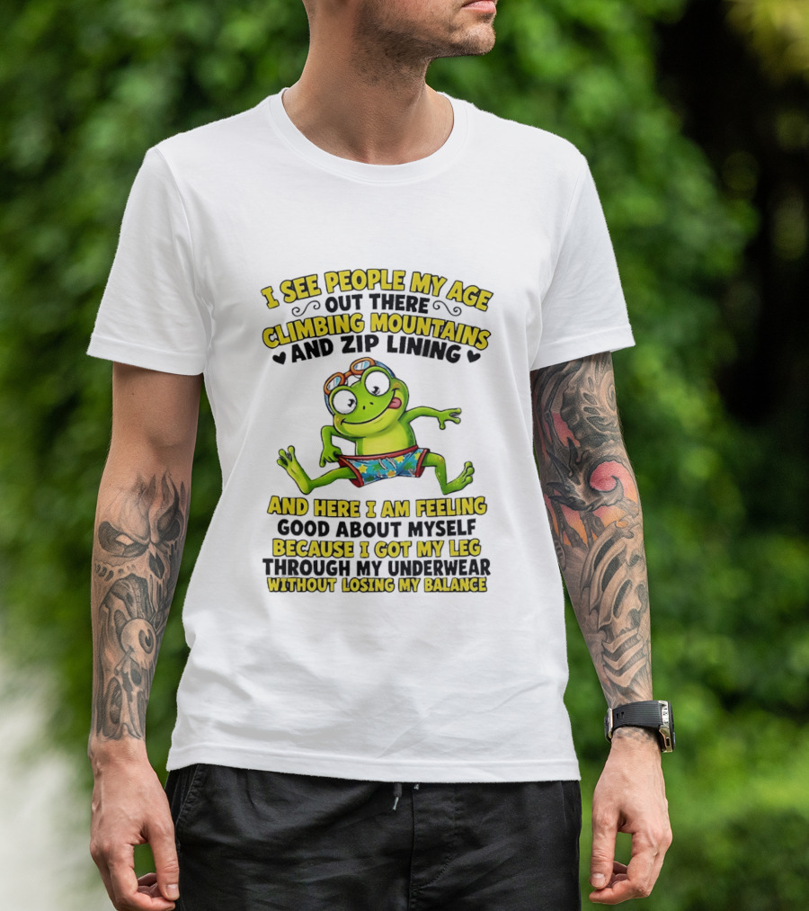 I See People My Age Climbing Mountains And Zip Lining Cartoon Frog Feeling Good Without Losing Balance T-Shirt