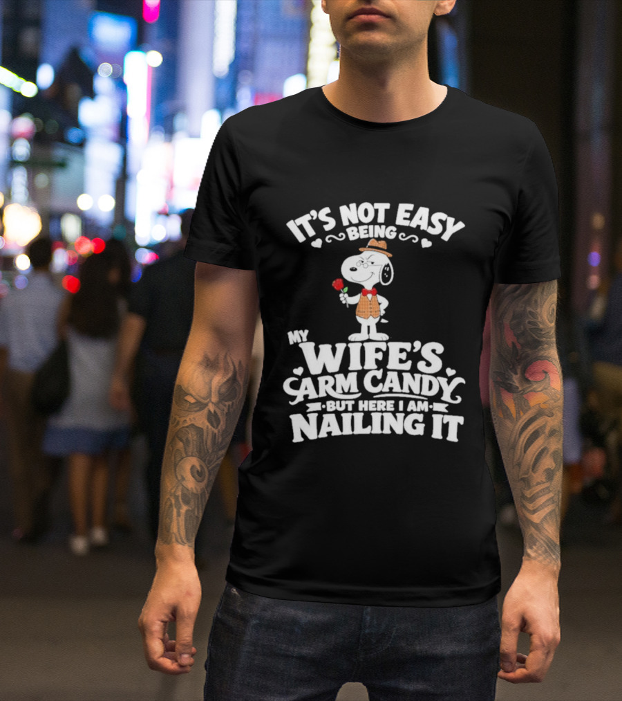 Snoopy It's Not Easy Being My Wife's Arm Candy But Here I Am Nailing It T-Shirt