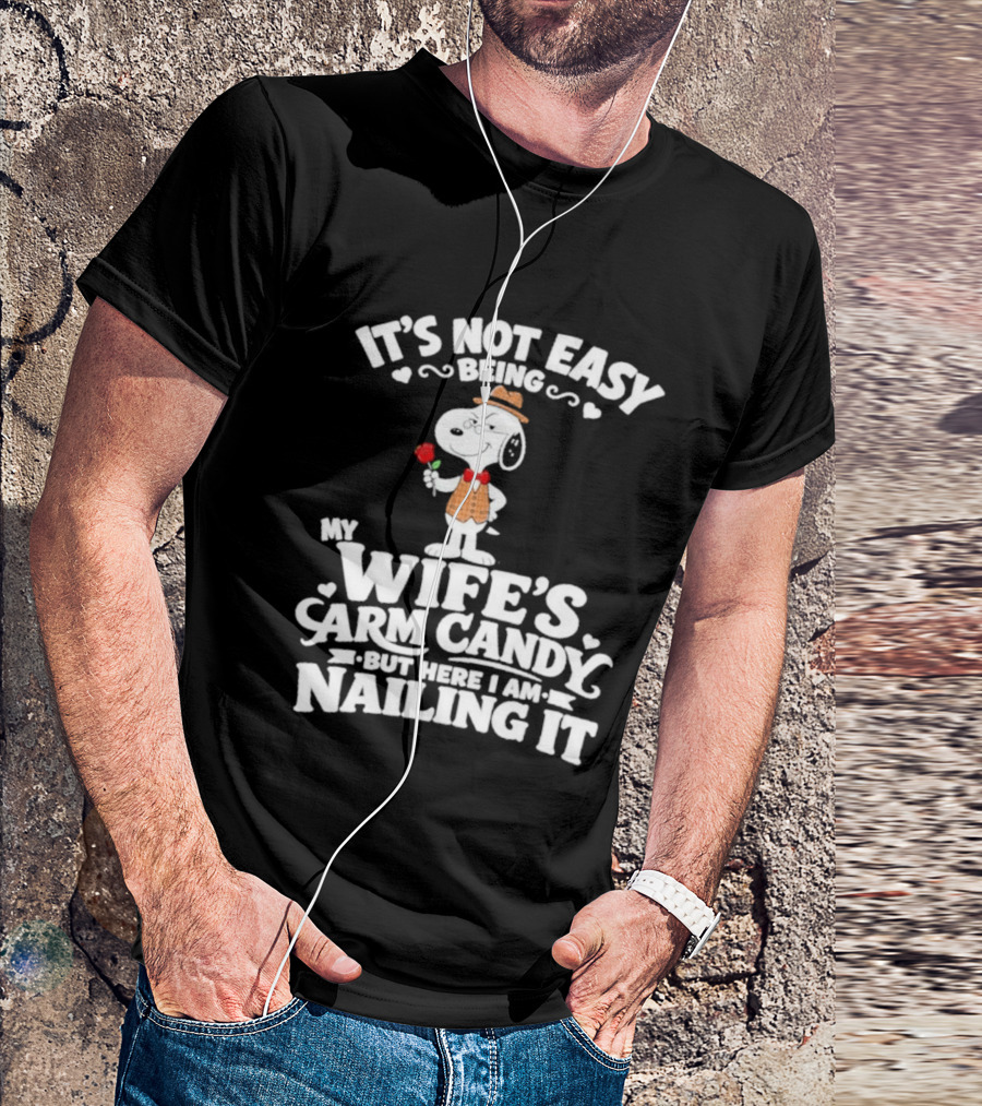 Snoopy It's Not Easy Being My Wife's Arm Candy But Here I Am Nailing It T-Shirt