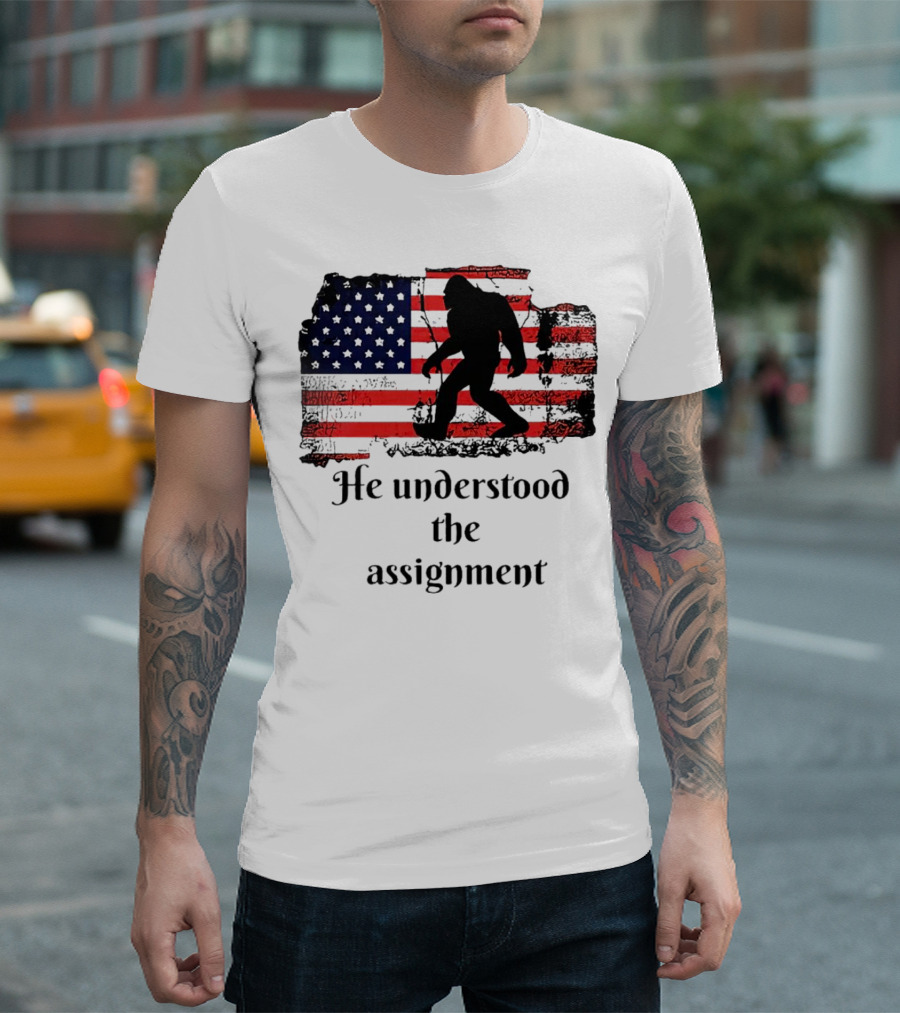 Bigfoot Silhouette with Distressed American Flag He Understood the Assignment T-Shirt