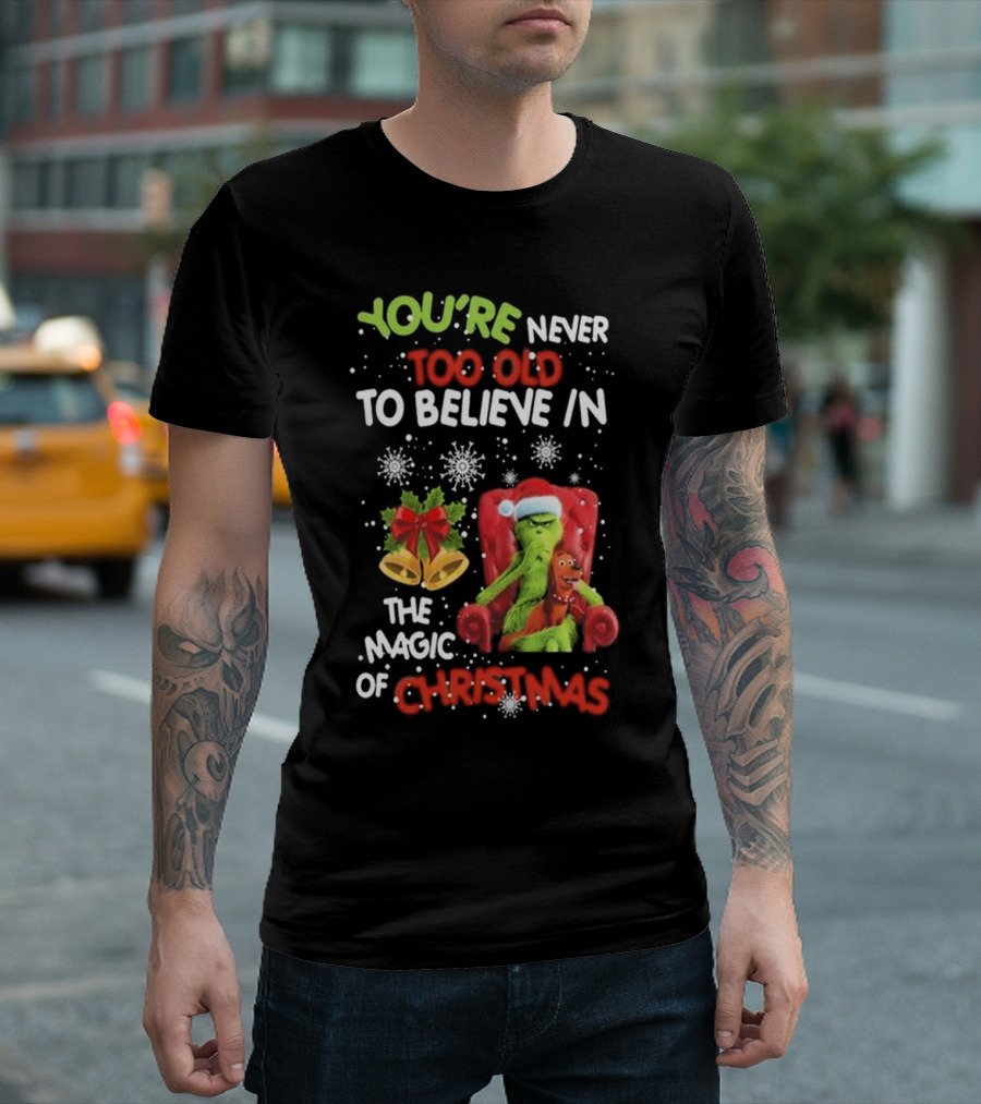 YOU'RE NEVER TOO OLD TO BELIEVE IN THE MAGIC OF CHRISTMAS GRINCH WITH MAX SITTING IN CHAIR SNOWFLAKES HOLIDAY BELLS AND BOW T-Shirt