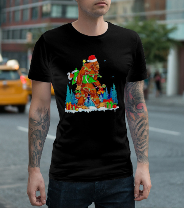 Bigfoot Santa Hugging Christmas Tree With Gifts And Snow Scene T-Shirt