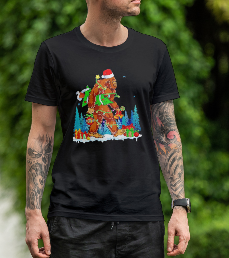 Bigfoot Santa Hugging Christmas Tree With Gifts And Snow Scene T-Shirt