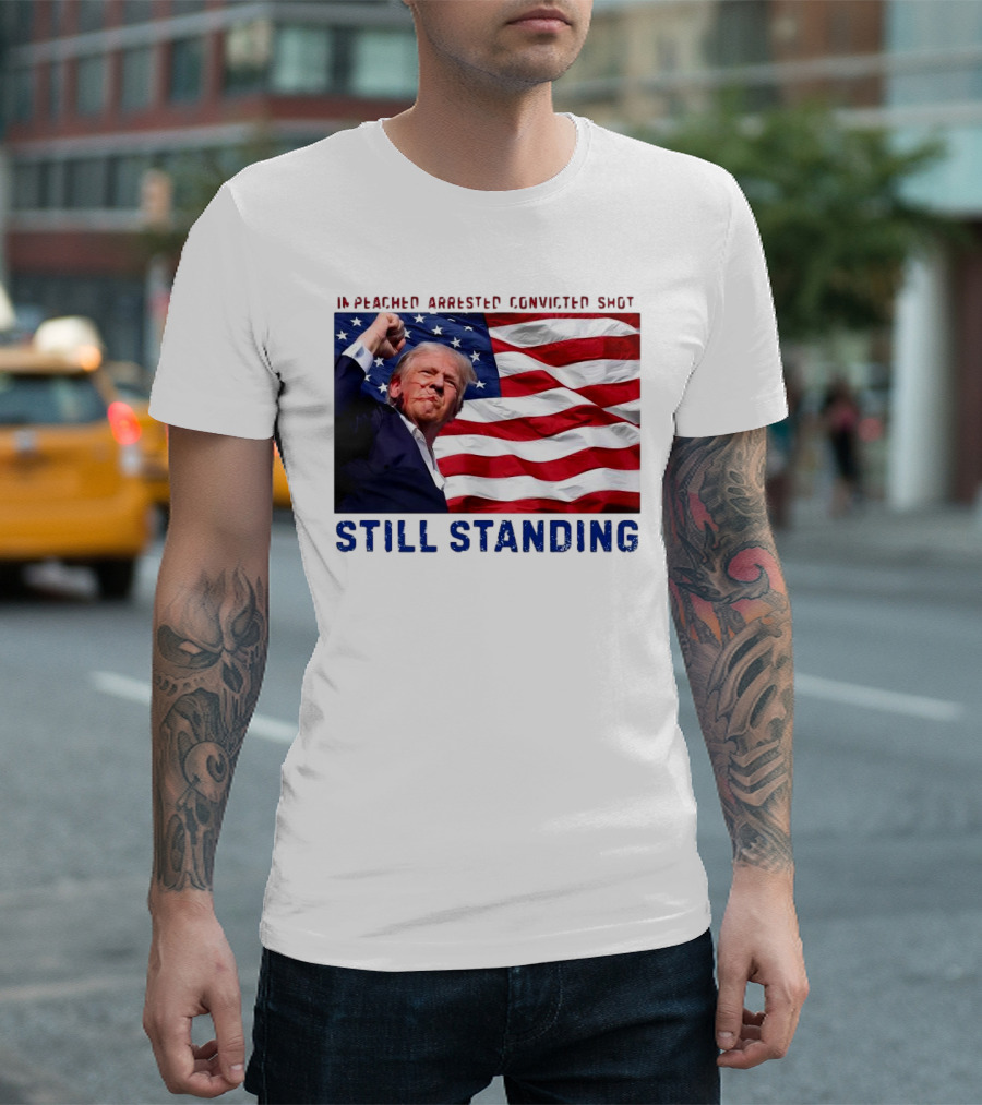 Still Standing Trump Impeached Arrested Convicted Shot American Flag Background T-Shirt